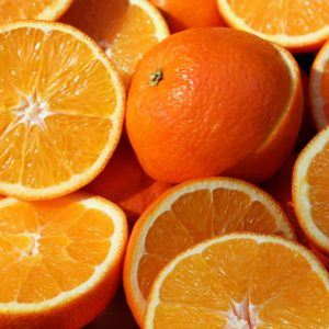 sliced orange fruit on brown wooden table