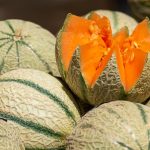 a group of melons with one cut in half