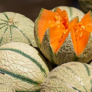 a group of melons with one cut in half