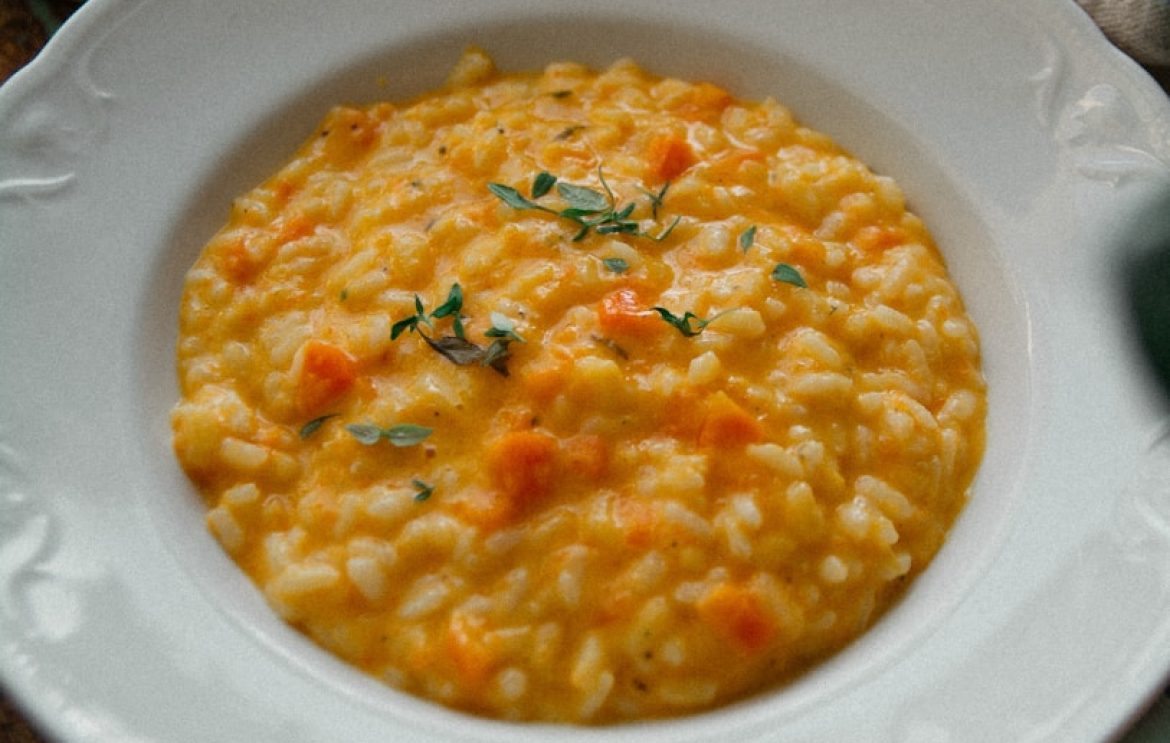 a white plate topped with a bowl of macaroni and cheese